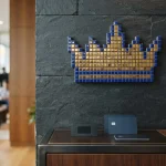 Pixel-art crown mosaic of gold and blue tiles, with a hardware wallet and payment cards below